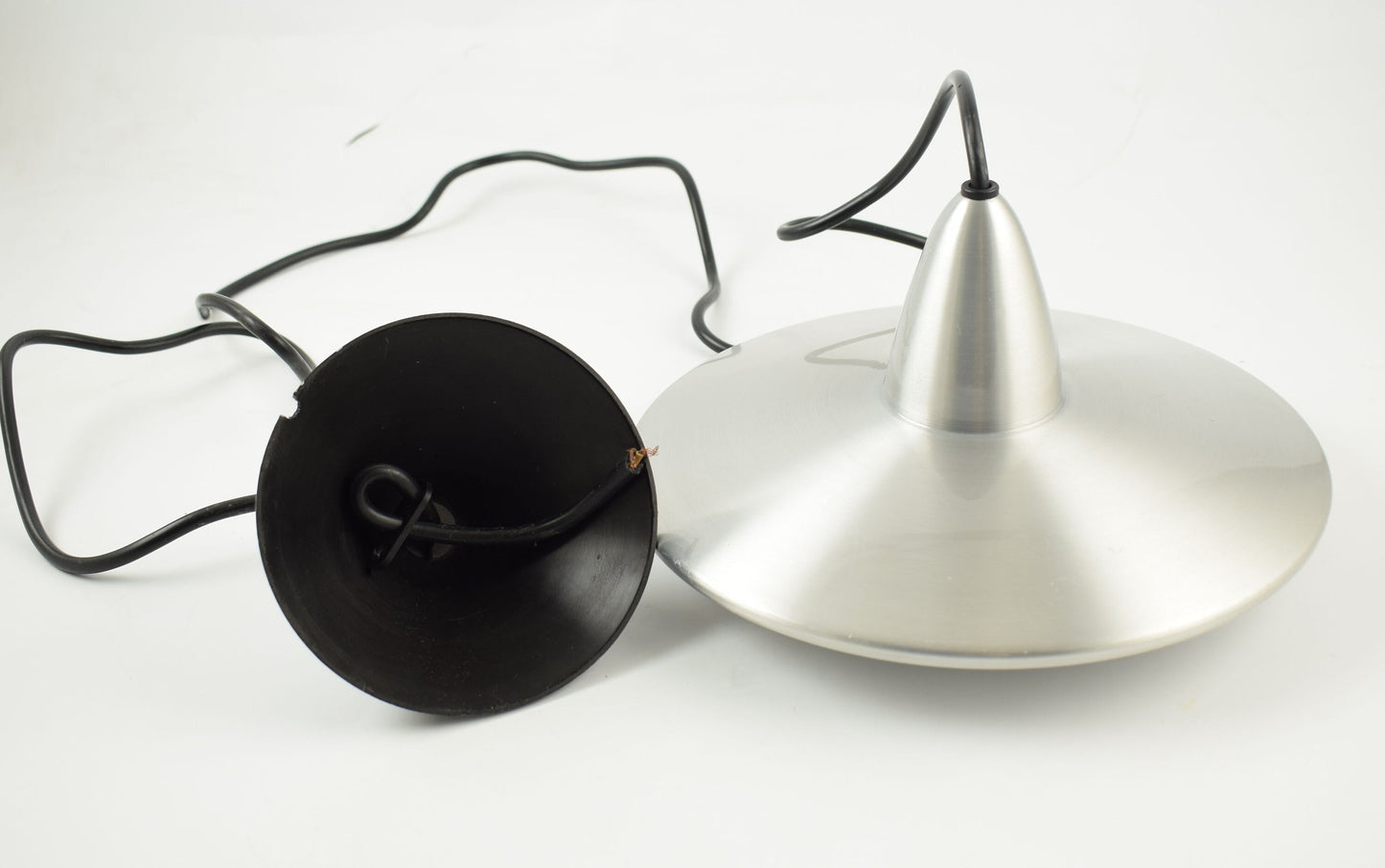 Aluminum hanging lamp in the shape of an ufo from dutch design company Hala.
