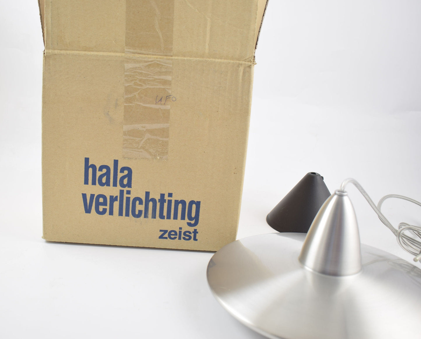 Aluminum hanging lamp in the shape of an ufo from dutch design company Hala.