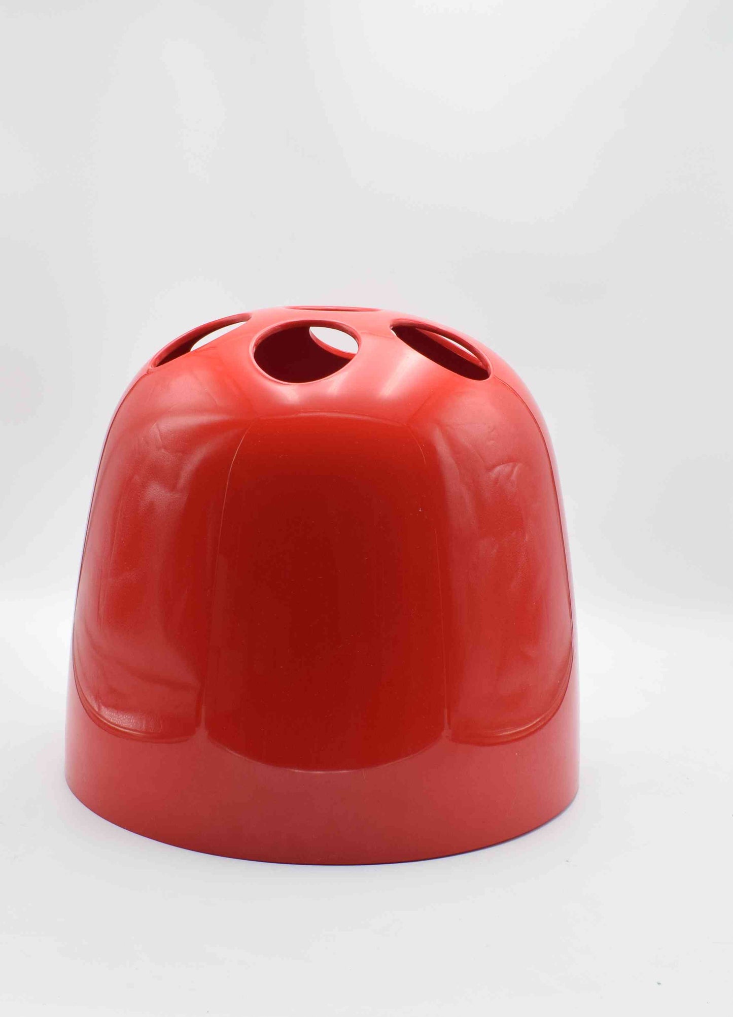 Red ceramic vase with a textured surface on a white background