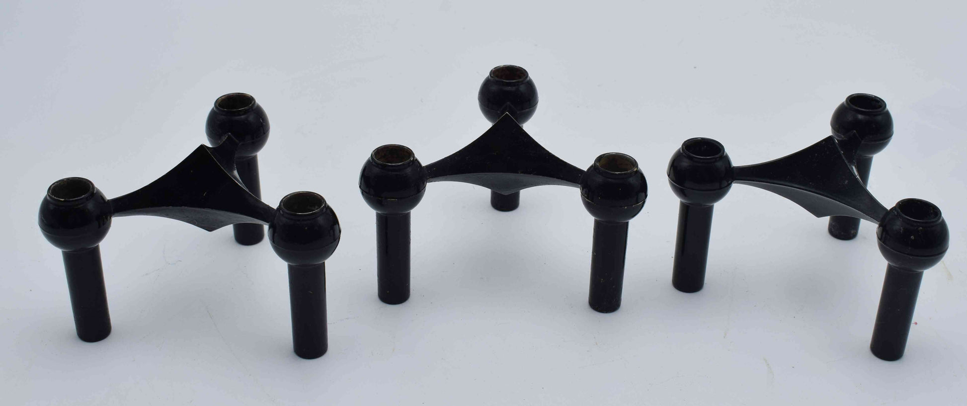 Set of black metal brackets on a white background