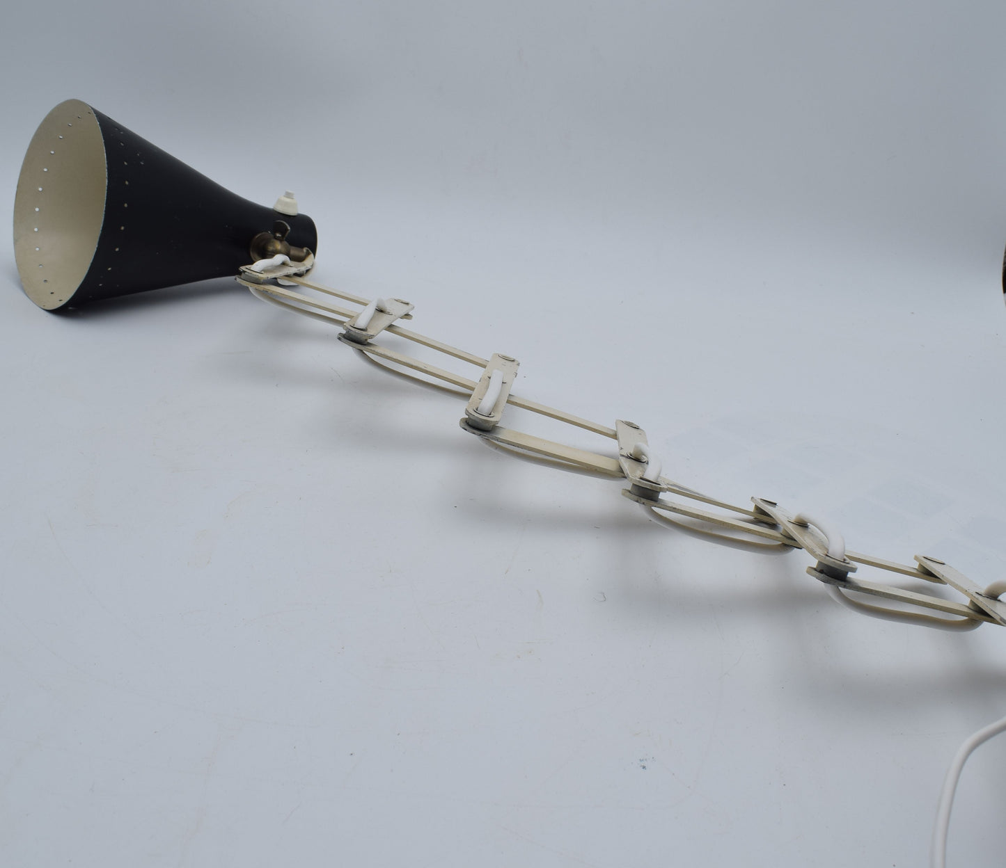 Black megaphone with a chain on a gray background