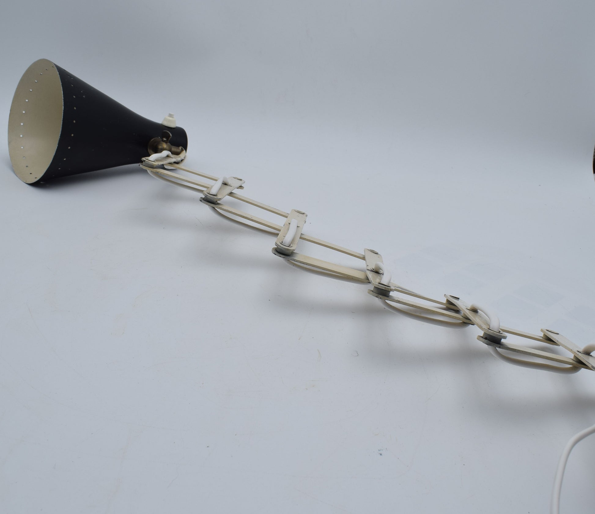 Black megaphone with a chain on a gray background