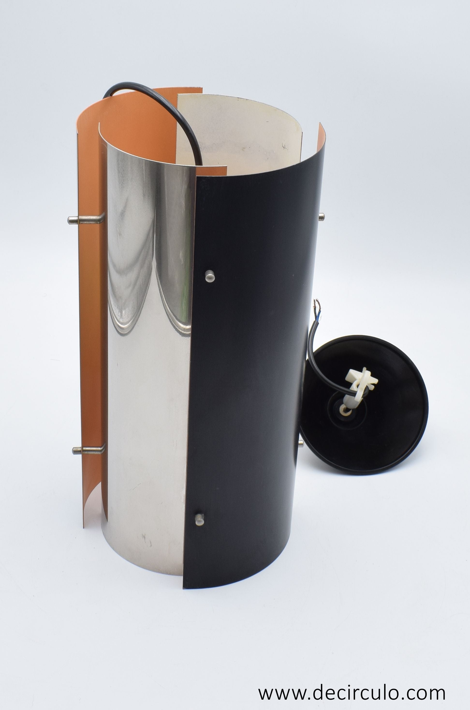 1970s Scandinavian pendant lamp with two black and two chrome quarter‑cylinder plates, chrome rods, and warm orange inner lacquer creating a directional glow