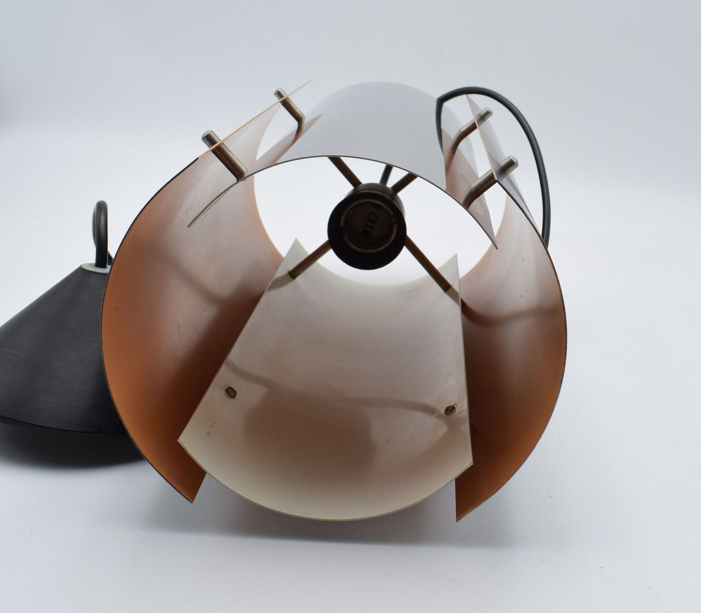 1970s Scandinavian pendant lamp with two black and two chrome quarter‑cylinder plates, chrome rods, and warm orange inner lacquer creating a directional glow