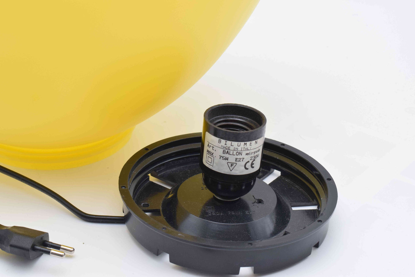Light bulb socket with a yellow helmet in the background