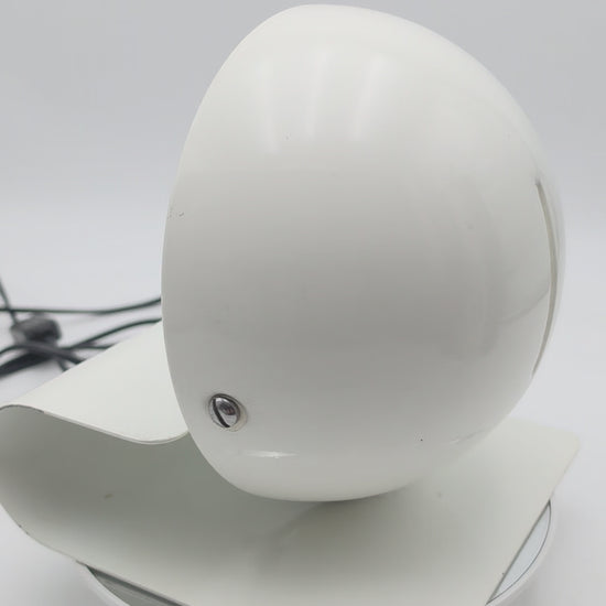 Bugia lamp in use, demonstrating the warm directional glow created when the adjustable shade is opened
