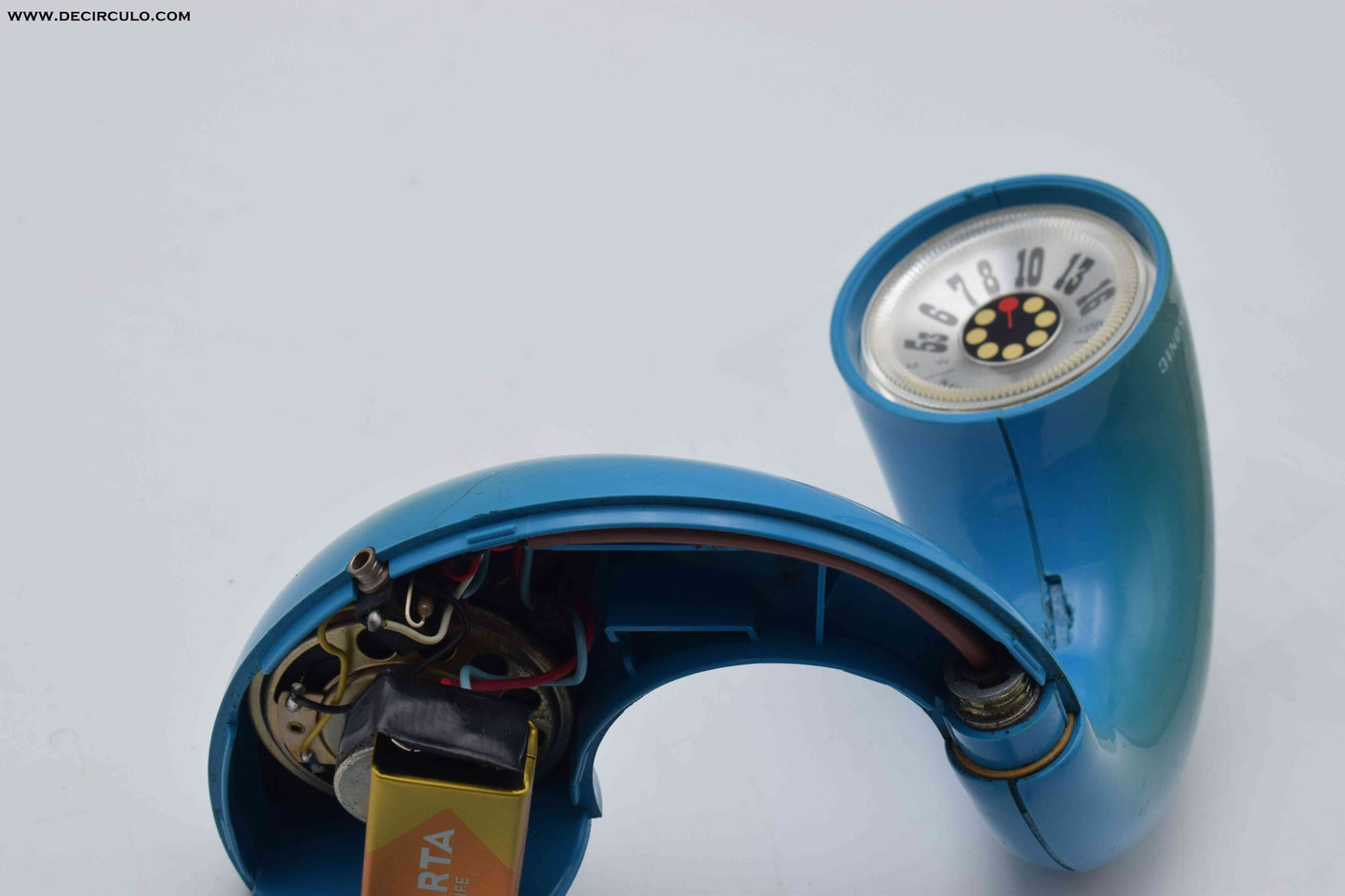 Blue handheld device with a circular component on a light gray background