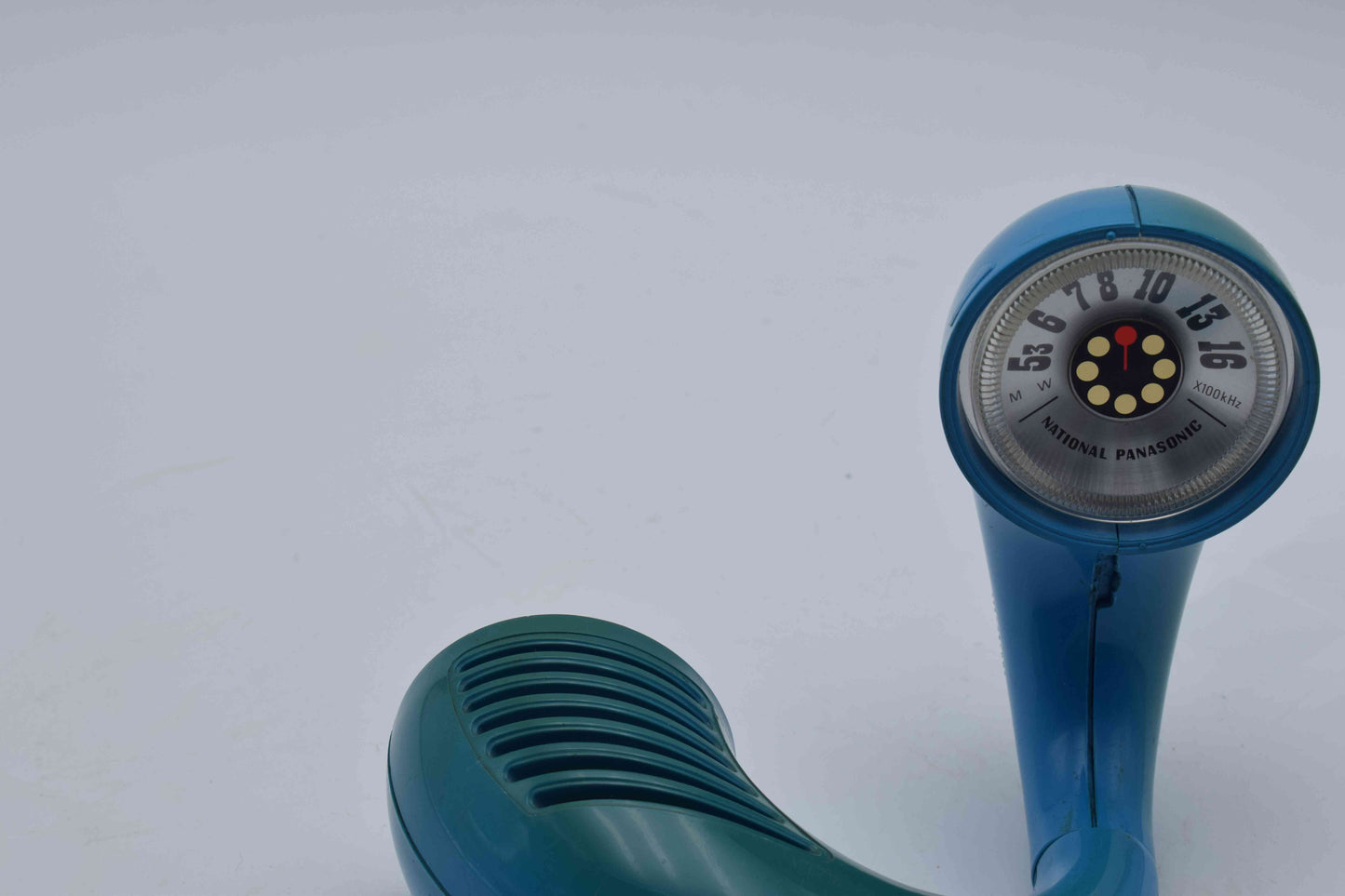 Blue vintage-style hand held shower head on a white background