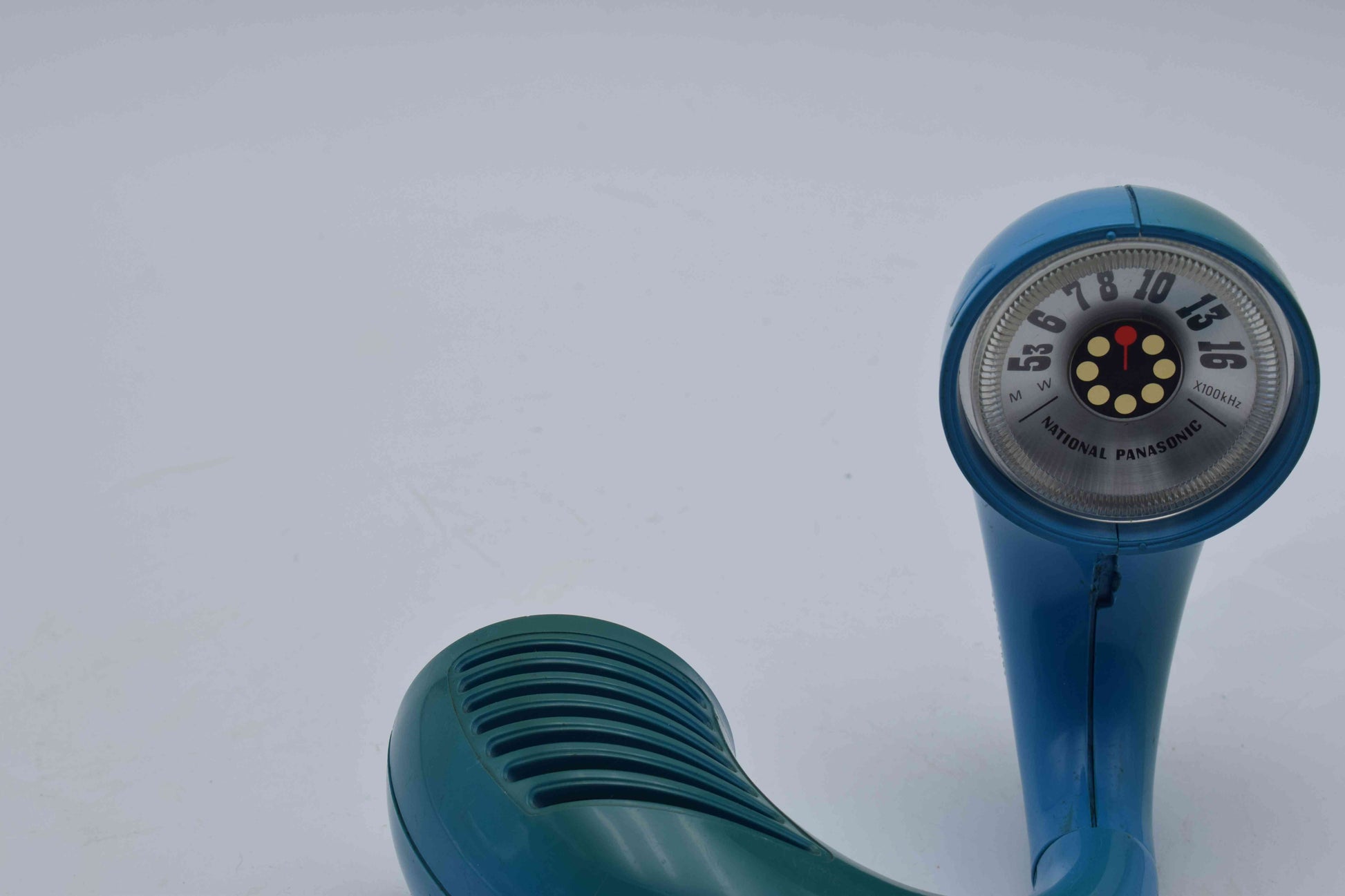 Blue vintage-style hand held shower head on a white background